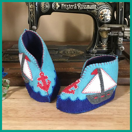 A picture that represents something you can make in the Hand Sewing class - felt baby booties with appliqué designs. The picture links to the page describing the Hand Sewing lesson.