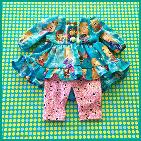 Picture of something you can make in Sewing 101 for Kids - a dress and leggings in colorful fabric for an 18 inch doll.