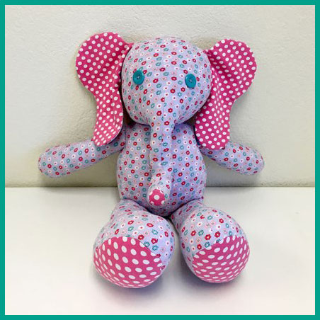 Picture of something you can make in Sewing 101 for Kids - a stuffed toy elephant made from pink and purple fabric. 